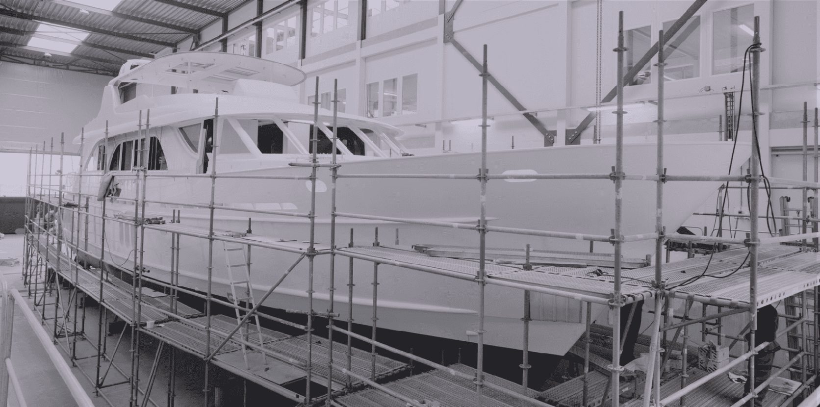 Superyacht under refit with scaffolding in the yard